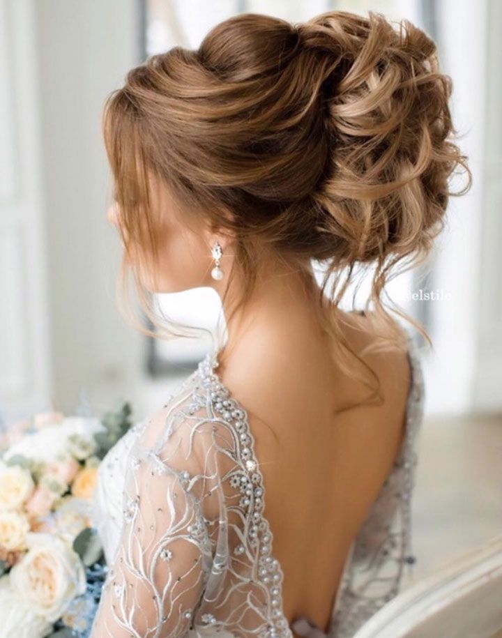 Romantic bridal hairstyle with embellished lace gown