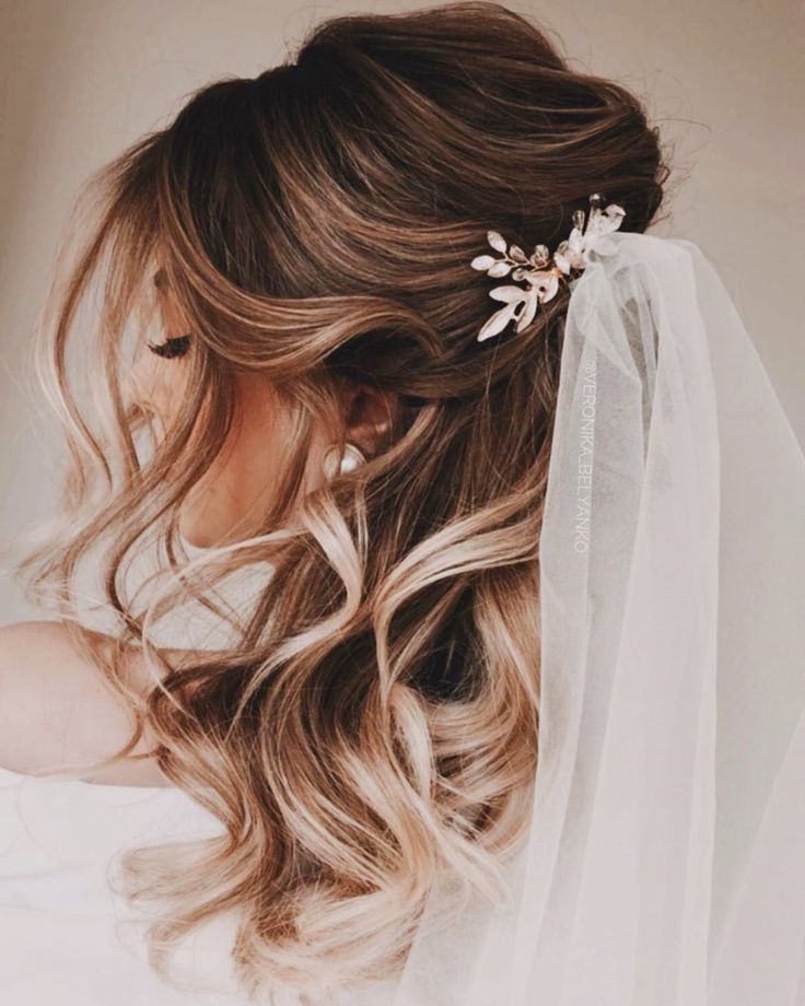 Bridal half-up half-down waves with crystal hair clip and veil